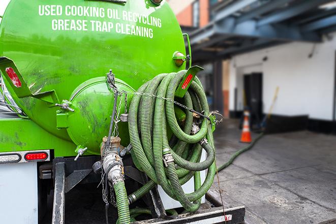 suction truck pumping grease trap for disposal in Buena